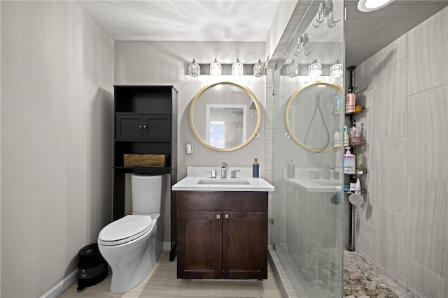 bathroom featuring vanity, toilet, and tiled shower