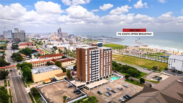 drone / aerial view with a water view and a beach view