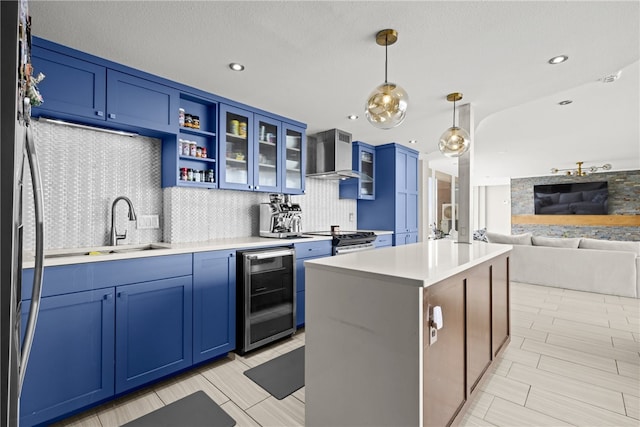 715 S Upper Broadway St Unit 1501, Corpus Christi, TX 78401 - kitchen with beverage cooler, blue cabinetry, wall chimney range hood, and recessed lighting
