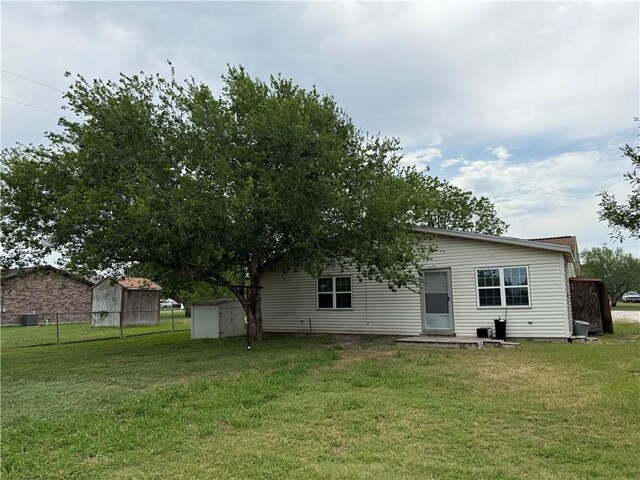 9047 County Road 471, Mathis, TX 78368 - rear view of house with a storage shed and an outdoor structure