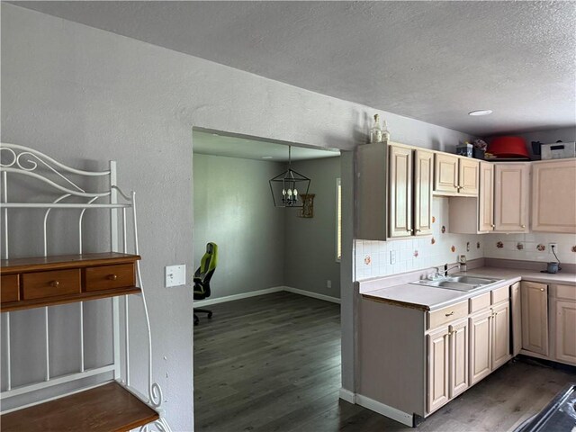 9047 County Road 471, Mathis, TX 78368 - kitchen featuring dark wood finished floors, a sink, backsplash, a textured ceiling, and a chandelier