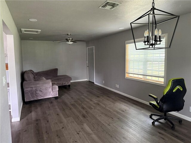 9047 County Road 471, Mathis, TX 78368 - sitting room with dark wood-type flooring, baseboards, a chandelier, and a textured ceiling