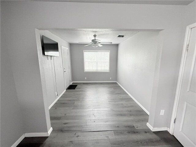 9047 County Road 471, Mathis, TX 78368 - unfurnished dining area featuring a ceiling fan, wood finished floors, and baseboards