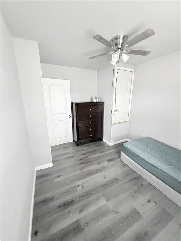 9047 County Road 471, Mathis, TX 78368 - bedroom featuring baseboards, wood finished floors, and a ceiling fan