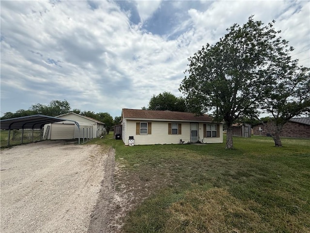 9047 County Road 471, Mathis, TX 78368 - view of front of house with a front lawn, a garage, driveway, and a detached carport
