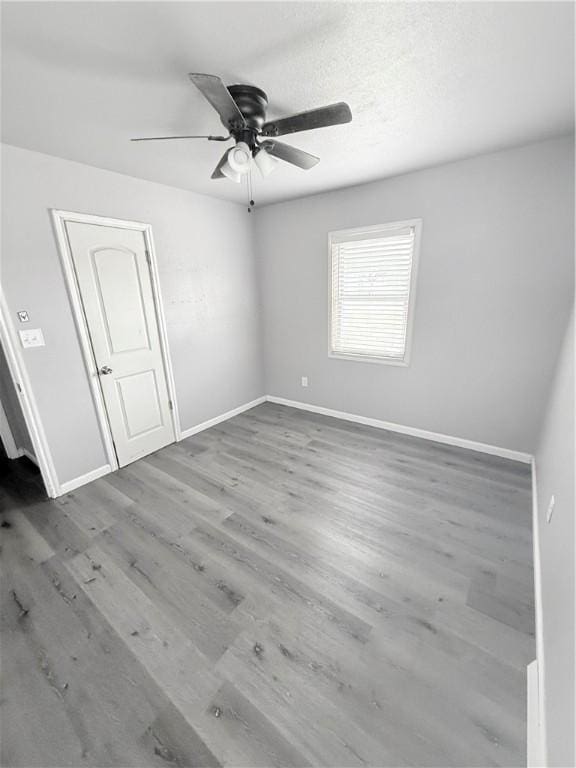 9047 County Road 471, Mathis, TX 78368 - empty room featuring a ceiling fan, baseboards, and wood finished floors