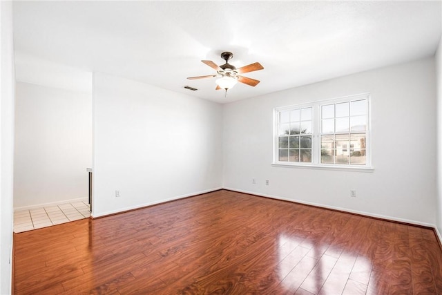 empty room with hardwood / wood-style flooring and ceiling fan