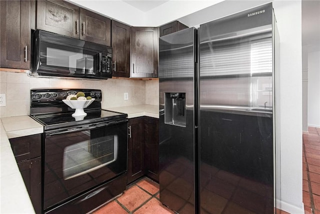 kitchen featuring decorative backsplash, dark brown cabinets, light tile patterned floors, and black appliances