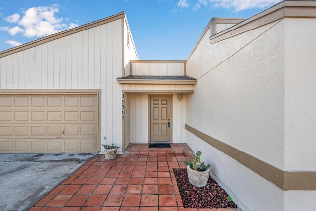 doorway to property with a garage