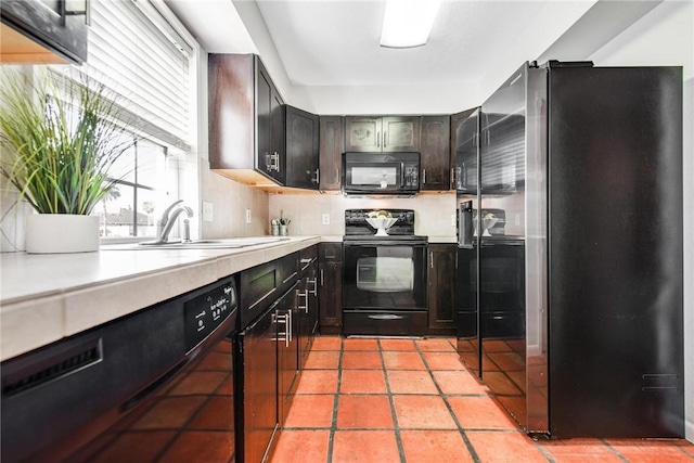 kitchen with backsplash, dark brown cabinets, sink, black appliances, and light tile patterned floors