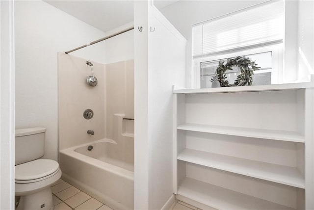 bathroom featuring tile patterned floors, bathing tub / shower combination, and toilet