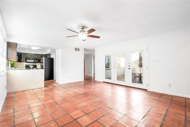 unfurnished living room with french doors and ceiling fan