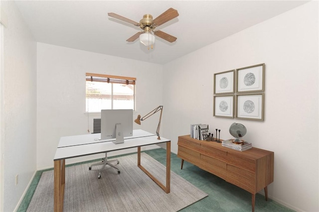 carpeted office space featuring ceiling fan