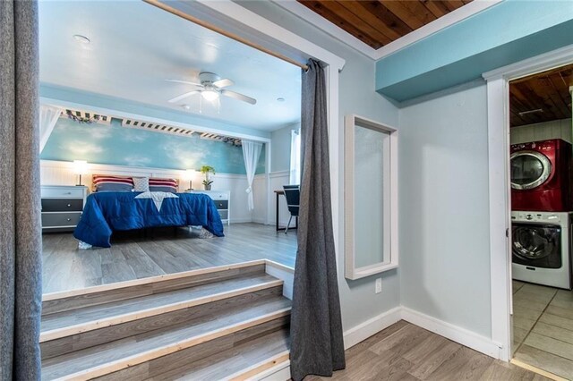 938 E Lakeside Dr, Corpus Christi, TX 78418 - bedroom featuring stacked washer and clothes dryer, wooden ceiling, wood finished floors, baseboards, and a ceiling fan
