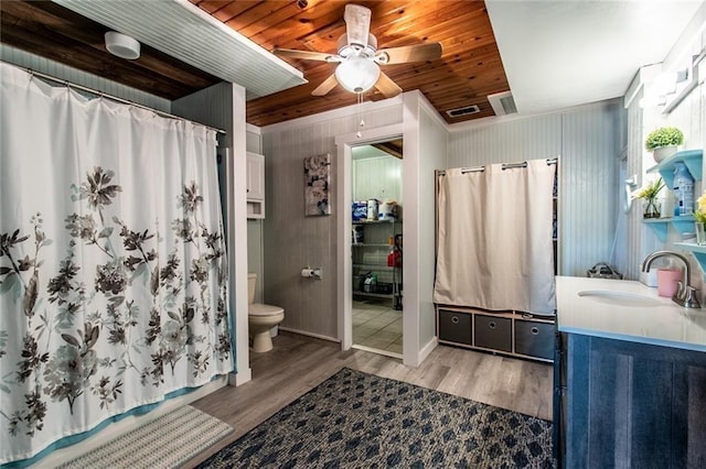 938 E Lakeside Dr, Corpus Christi, TX 78418 - bathroom with wood finished floors, vanity, toilet, a ceiling fan, and wooden ceiling