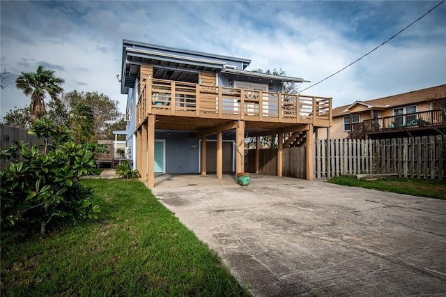 back of house with a lawn and a carport