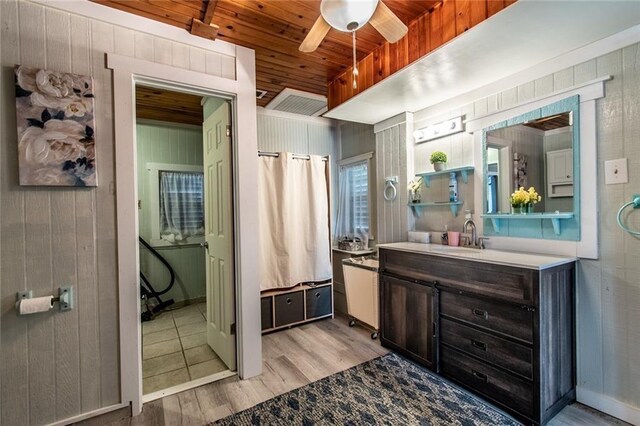 938 E Lakeside Dr, Corpus Christi, TX 78418 - bathroom featuring wood finished floors, wooden ceiling, a ceiling fan, vanity, and wooden walls