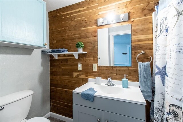 938 E Lakeside Dr, Corpus Christi, TX 78418 - full bath with wood walls, vanity, toilet, baseboards, and a shower with curtain