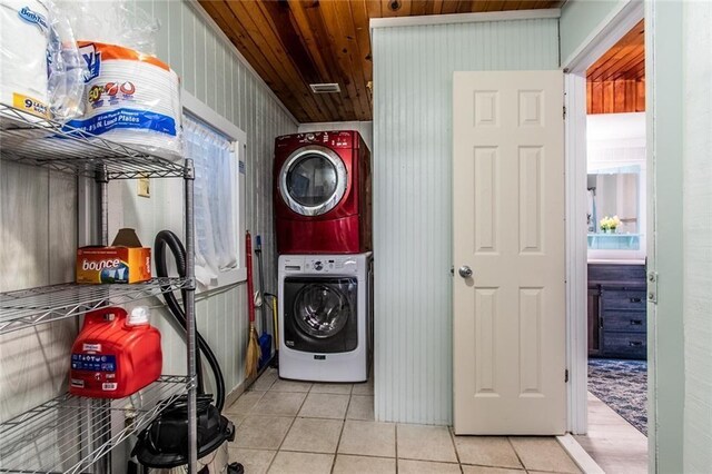 938 E Lakeside Dr, Corpus Christi, TX 78418 - washroom featuring estacked washer and dryer, light tile patterned flooring, and wood ceiling