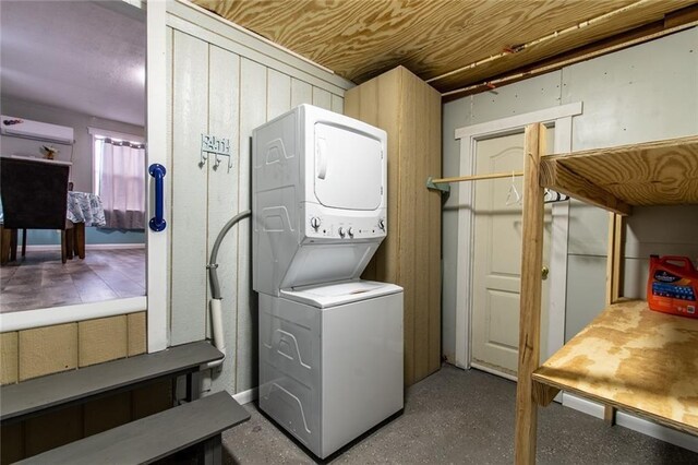 938 E Lakeside Dr, Corpus Christi, TX 78418 - laundry room with stacked washer and clothes dryer and a wall mounted air conditioner