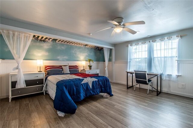 938 E Lakeside Dr, Corpus Christi, TX 78418 - bedroom with a wainscoted wall, wood finished floors, and ceiling fan