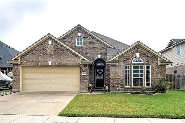 front of property featuring a garage and a front lawn