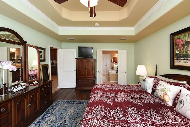 bedroom with dark hardwood / wood-style floors, ensuite bath, a raised ceiling, and ceiling fan