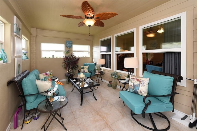 sunroom featuring ceiling fan