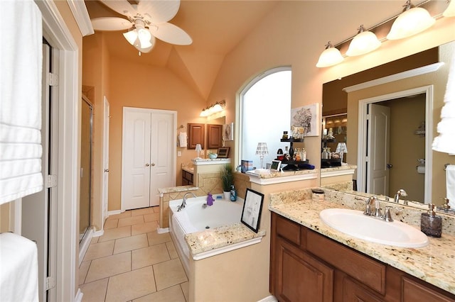 bathroom with vaulted ceiling, vanity, independent shower and bath, ceiling fan, and tile patterned flooring