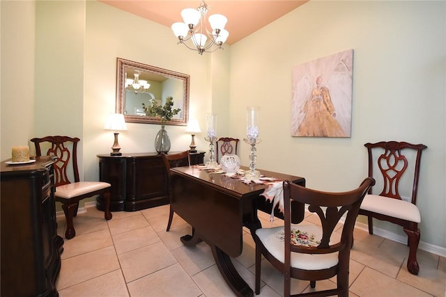 tiled dining room with an inviting chandelier