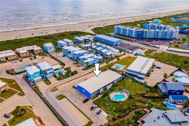 bird's eye view featuring a view of the beach and a water view