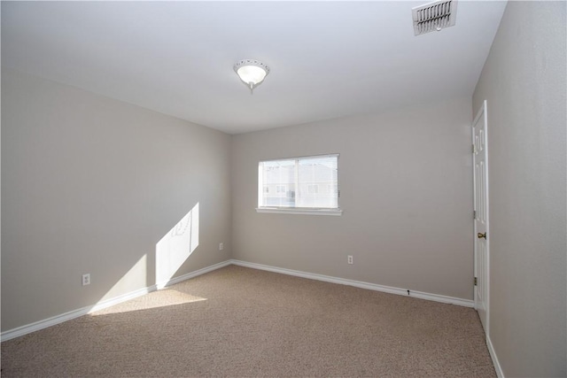 unfurnished room with baseboards, visible vents, and light colored carpet