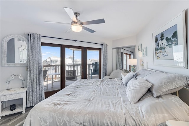 bedroom featuring dark hardwood / wood-style flooring, access to outside, french doors, and ceiling fan