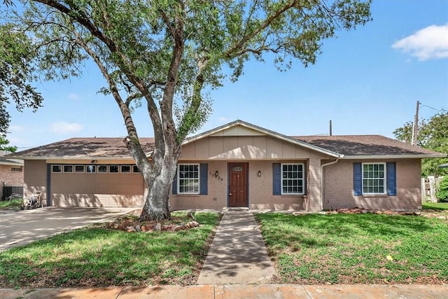 11129 Mulholland Dr, Corpus Christi, TX 78410 - ranch-style home featuring an attached garage, a front lawn, driveway, and brick siding