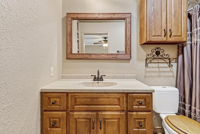 11129 Mulholland Dr, Corpus Christi, TX 78410 - bathroom featuring a textured wall, vanity, and ceiling fan