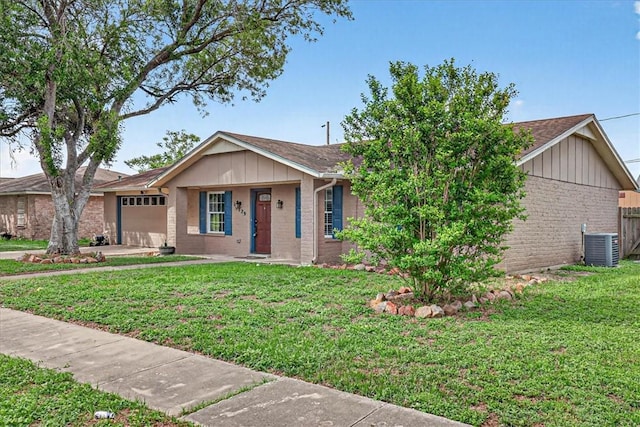 11129 Mulholland Dr, Corpus Christi, TX 78410 - single story home with brick siding, an attached garage, a front lawn, and board and batten siding