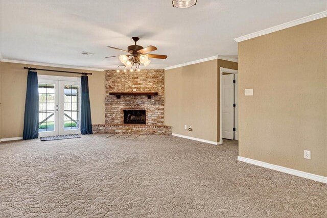 11129 Mulholland Dr, Corpus Christi, TX 78410 - unfurnished living room featuring a ceiling fan, carpet flooring, ornamental molding, french doors, and a fireplace