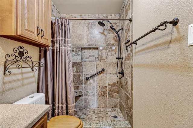 11129 Mulholland Dr, Corpus Christi, TX 78410 - bathroom featuring a tile shower, vanity, and a textured wall