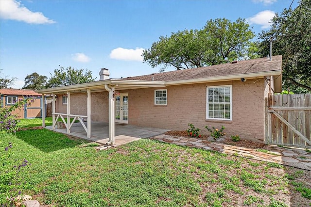 11129 Mulholland Dr, Corpus Christi, TX 78410 - rear view of property with french doors, a patio, a chimney, a storage unit, and brick siding