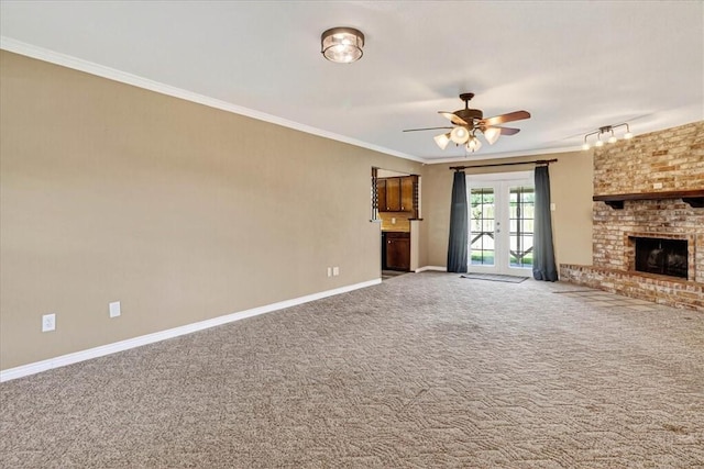 11129 Mulholland Dr, Corpus Christi, TX 78410 - unfurnished living room featuring a ceiling fan, carpet floors, crown molding, and a brick fireplace