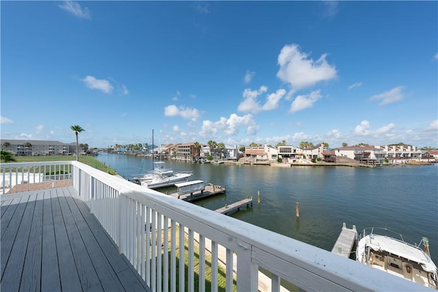 wooden terrace with a water view and a boat dock