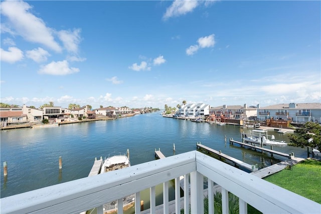 water view featuring nearby suburban area and a boat dock