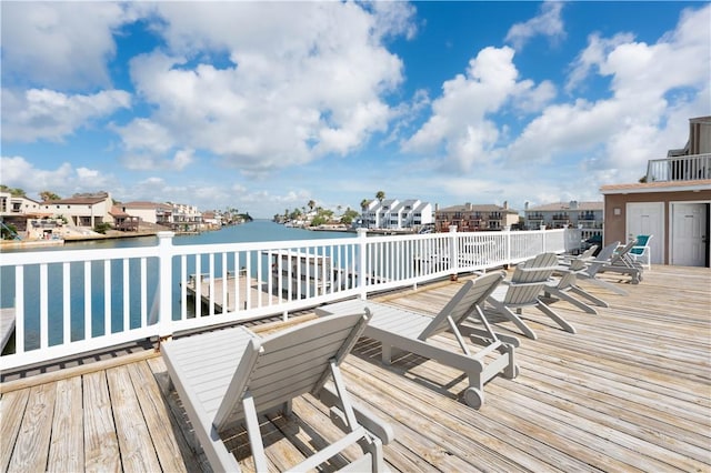 wooden deck featuring a water view and a residential view