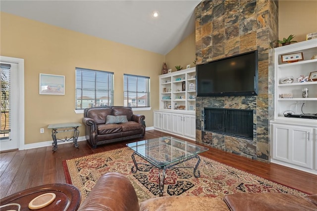 227 Windjammer St, Rockport, TX 78382 - living room featuring wood-type flooring, healthy amount of natural light, a tile fireplace, baseboards, and high vaulted ceiling
