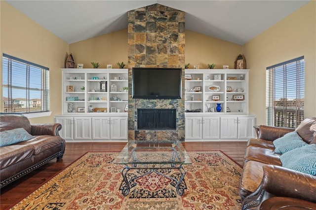 227 Windjammer St, Rockport, TX 78382 - living area featuring a fireplace, wood finished floors, vaulted ceiling, and healthy amount of natural light