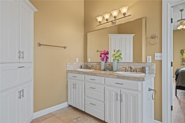 227 Windjammer St, Rockport, TX 78382 - bathroom featuring double vanity, tasteful backsplash, baseboards, and tile patterned flooring
