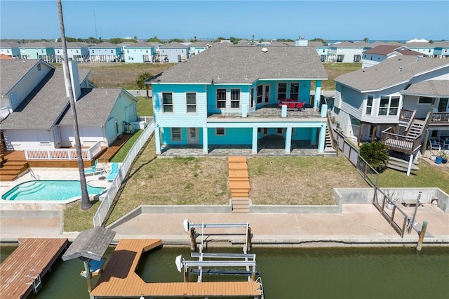 227 Windjammer St, Rockport, TX 78382 - back of house with a residential view, boat lift, and a water view