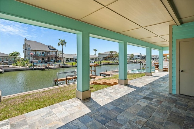 227 Windjammer St, Rockport, TX 78382 - view of patio featuring a water view, a boat dock, and a residential view
