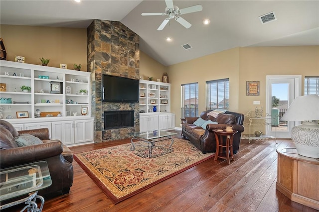 227 Windjammer St, Rockport, TX 78382 - living room featuring high vaulted ceiling, healthy amount of natural light, hardwood / wood-style floors, a ceiling fan, and a stone fireplace