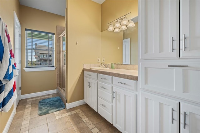 227 Windjammer St, Rockport, TX 78382 - full bath with vanity, a shower stall, baseboards, and tile patterned flooring
